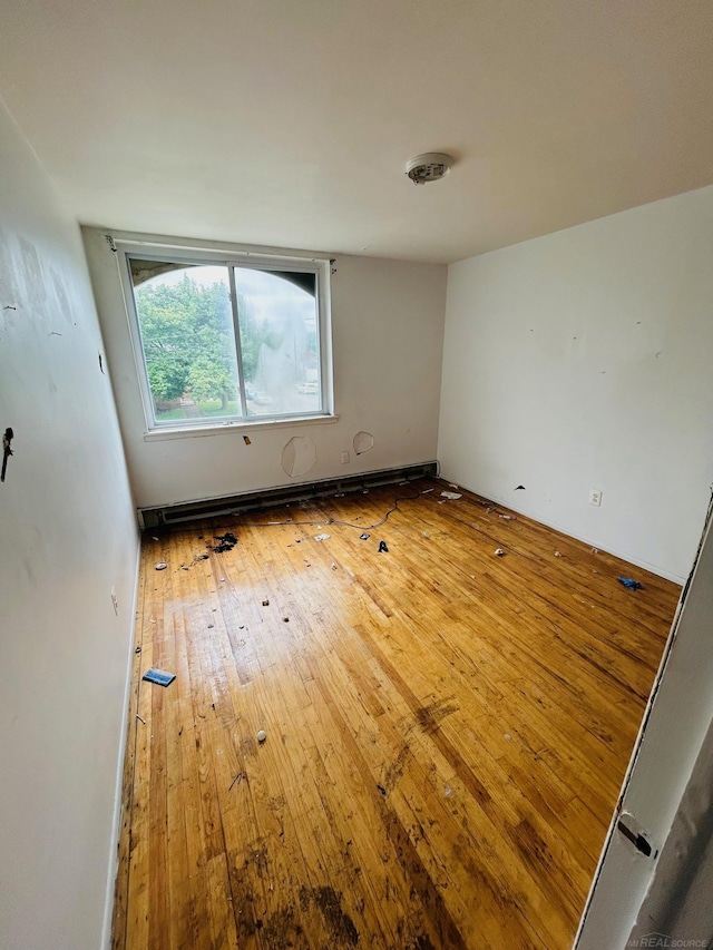 16600-16620 Greenfield Rd, Detroit, MI 48235 - empty room featuring wood-type flooring and baseboard heating