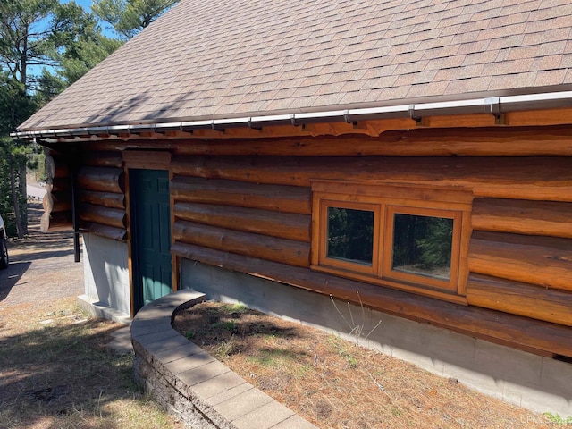 6856 Five Mile Point Rd, Allouez, MI 49805 - view of side of property featuring roof with shingles and log exterior