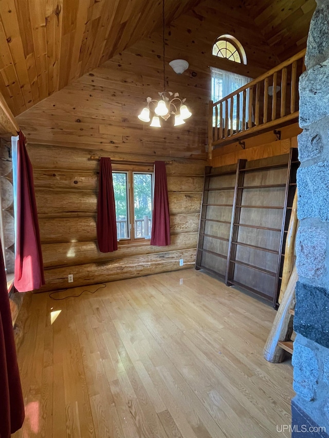 6856 Five Mile Point Rd, Allouez, MI 49805 - unfurnished living room featuring wood ceiling, rustic walls, high vaulted ceiling, healthy amount of natural light, and hardwood / wood-style floors