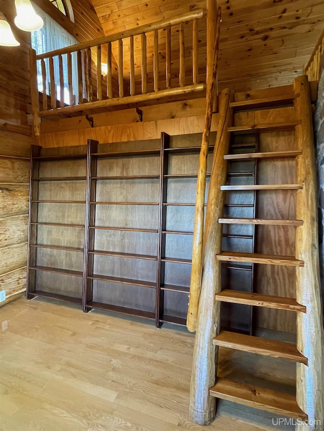 6856 Five Mile Point Rd, Allouez, MI 49805 - staircase with wood finished floors, vaulted ceiling, wood ceiling, and wood walls