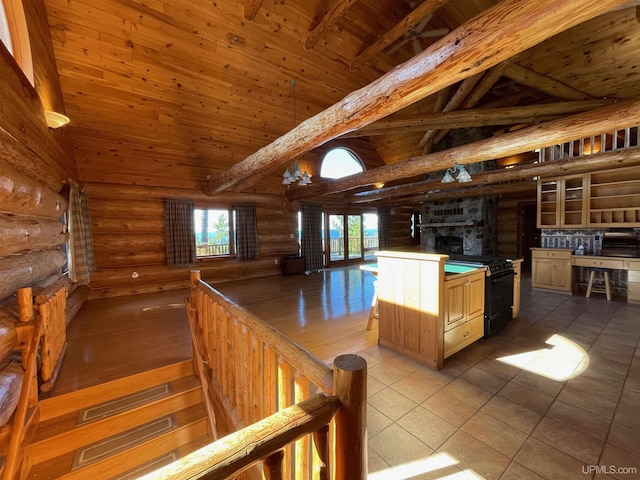 6856 Five Mile Point Rd, Allouez, MI 49805 - kitchen with rustic walls, black gas stove, wooden ceiling with exposed beams, healthy amount of natural light, and high vaulted ceiling