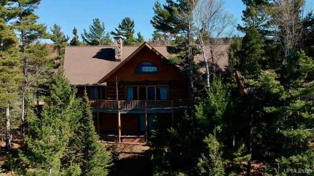 6856 Five Mile Point Rd, Allouez, MI 49805 - rear view of property featuring a wooden deck, a chimney, and a shingled roof