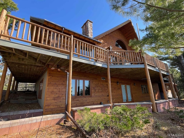 6856 Five Mile Point Rd, Allouez, MI 49805 - back of house with a chimney and a deck