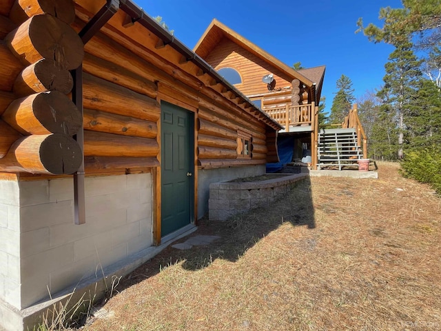 6856 Five Mile Point Rd, Allouez, MI 49805 - view of property exterior with log siding, stairway, and a wooden deck