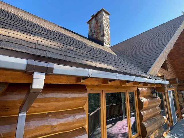 6856 Five Mile Point Rd, Allouez, MI 49805 - exterior view of a shingled roof and a chimney