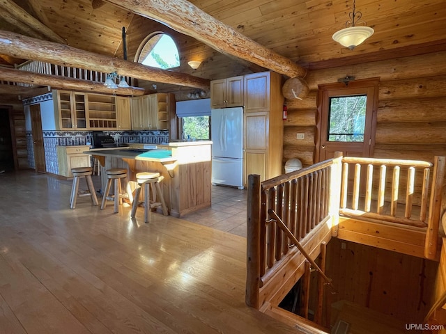 6856 Five Mile Point Rd, Allouez, MI 49805 - kitchen with white refrigerator, open shelves, rustic walls, a kitchen island, and wooden ceiling