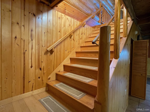6856 Five Mile Point Rd, Allouez, MI 49805 - staircase featuring wooden walls and wood-type flooring