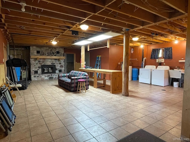6856 Five Mile Point Rd, Allouez, MI 49805 - finished basement featuring washer and clothes dryer, tile patterned flooring, a stone fireplace, and a sink