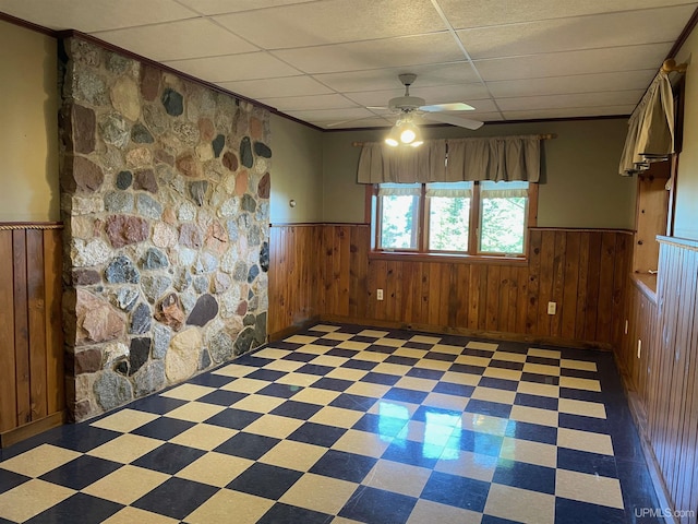 6856 Five Mile Point Rd, Allouez, MI 49805 - empty room with wainscoting, a ceiling fan, light flooring, and a paneled ceiling
