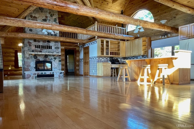 6856 Five Mile Point Rd, Allouez, MI 49805 - unfurnished living room with high vaulted ceiling, hardwood / wood-style flooring, wood ceiling with exposed beams, and a stone fireplace