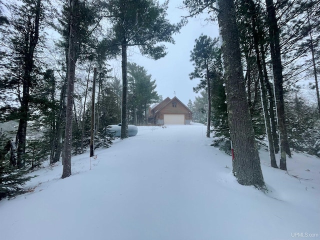 6856 Five Mile Point Rd, Allouez, MI 49805 - yard layered in snow featuring a garage