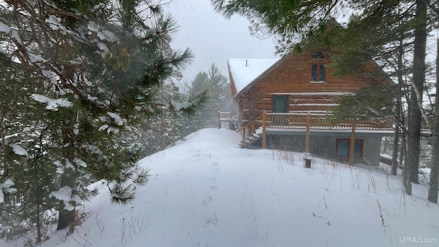 6856 Five Mile Point Rd, Allouez, MI 49805 - snow covered property featuring a deck, stairway, and log siding