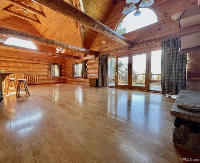 6856 Five Mile Point Rd, Allouez, MI 49805 - living area featuring log walls, wooden ceiling with exposed beams, high vaulted ceiling, plenty of natural light, and hardwood / wood-style floors