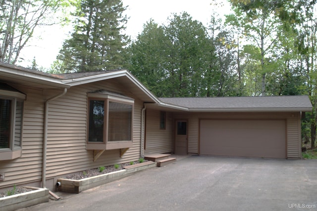 1001 Spruce St, Houghton, MI 49931 - ranch-style home with a garage and driveway