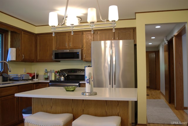 1001 Spruce St, Houghton, MI 49931 - kitchen featuring stainless steel appliances, light countertops, a breakfast bar, pendant lighting, and recessed lighting