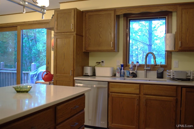 1001 Spruce St, Houghton, MI 49931 - kitchen with dishwasher, a sink, light countertops, and brown cabinets