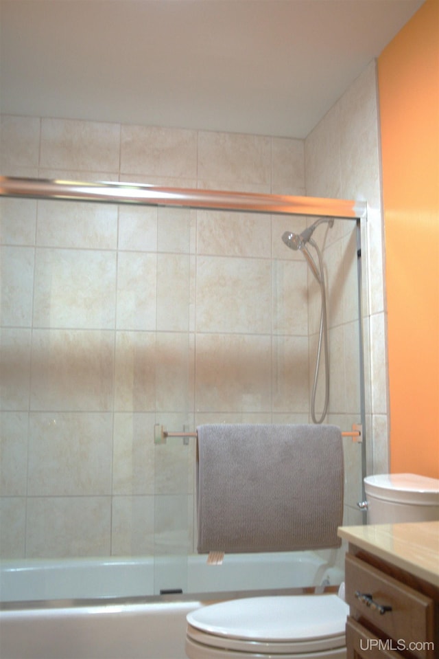 1001 Spruce St, Houghton, MI 49931 - full bathroom featuring toilet, shower / bath combination with glass door, and vanity