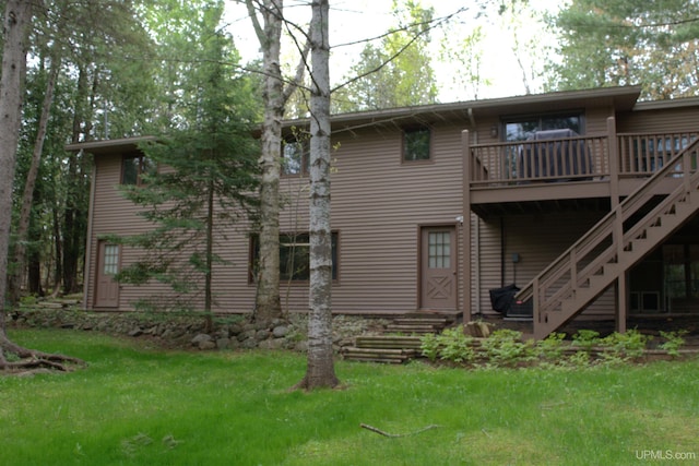 1001 Spruce St, Houghton, MI 49931 - rear view of property with a deck, a lawn, and stairway