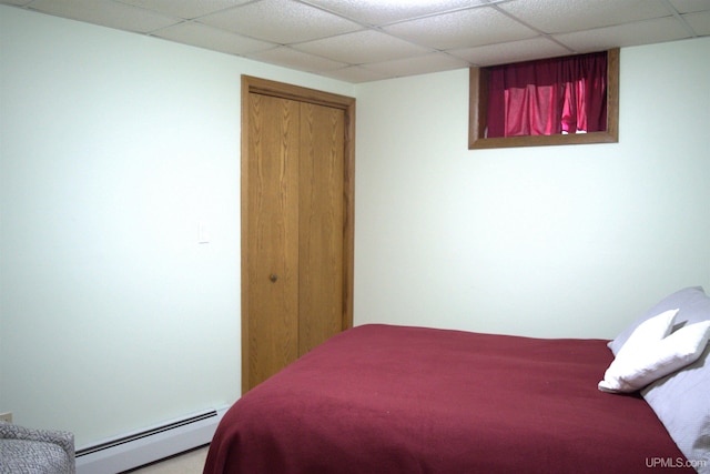 1001 Spruce St, Houghton, MI 49931 - bedroom with baseboard heating, a paneled ceiling, and a closet