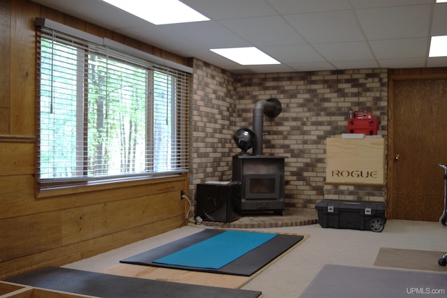 1001 Spruce St, Houghton, MI 49931 - workout room featuring a wood stove and carpet flooring
