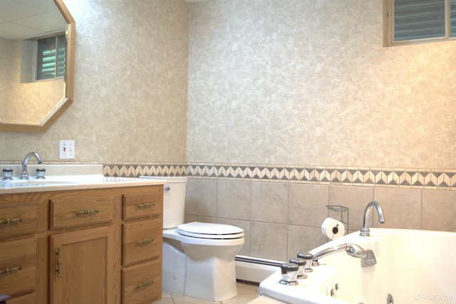 1001 Spruce St, Houghton, MI 49931 - bathroom featuring a jetted tub, vanity, baseboard heating, toilet, and wallpapered walls