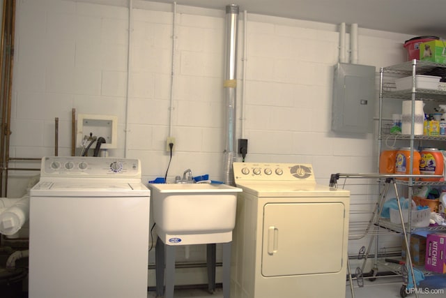 1001 Spruce St, Houghton, MI 49931 - washroom with electric panel, concrete block wall, washing machine and clothes dryer, and a baseboard heating unit