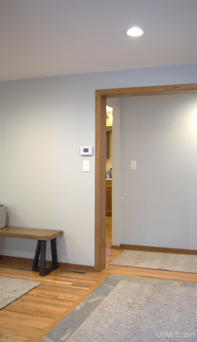 1001 Spruce St, Houghton, MI 49931 - hall with wood finished floors, baseboards, and recessed lighting