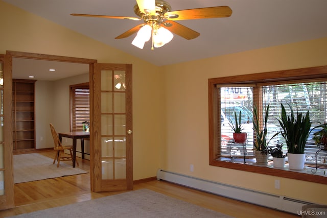1001 Spruce St, Houghton, MI 49931 - unfurnished room featuring a baseboard radiator, wood finished floors, lofted ceiling, and a ceiling fan