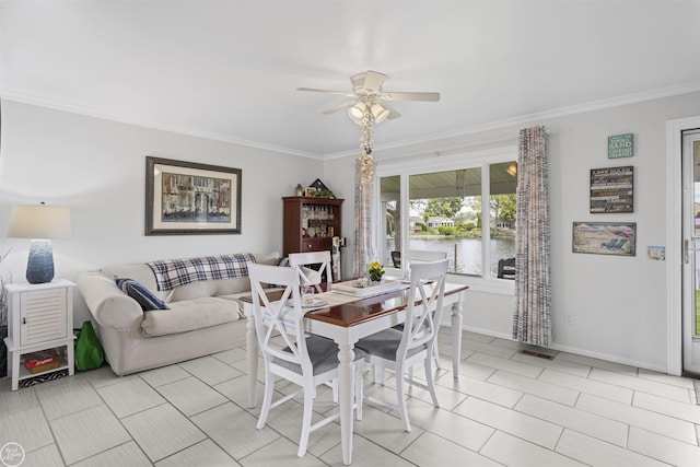8878 Arlington Rd, White Lake, MI 48386 - dining area featuring crown molding, a ceiling fan, a water view, and baseboards