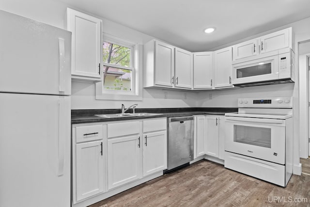 49058 Douglas St, Hancock, MI 49930 - kitchen featuring white appliances, a sink, white cabinetry, light wood-style floors, and recessed lighting