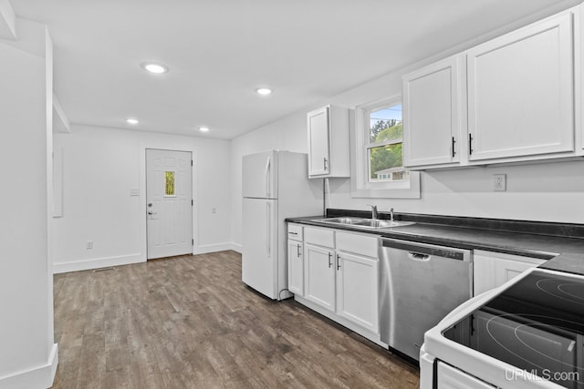 49058 Douglas St, Hancock, MI 49930 - kitchen with white appliances, a sink, dark wood finished floors, white cabinetry, and recessed lighting