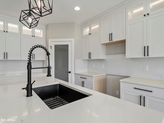 55127 Saint Paul Dr, Macomb Twp, MI 48042 - kitchen featuring a sink, white cabinetry, pendant lighting, recessed lighting, and backsplash