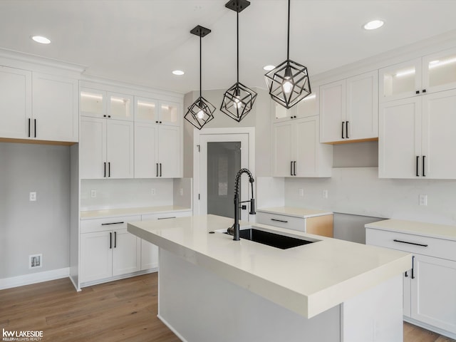 55127 Saint Paul Dr, Macomb Twp, MI 48042 - kitchen featuring a sink, recessed lighting, a kitchen island with sink, backsplash, and pendant lighting