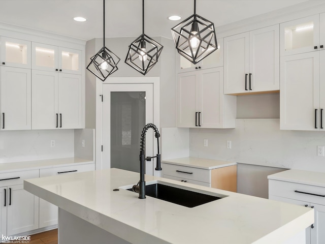 55127 Saint Paul Dr, Macomb Twp, MI 48042 - kitchen with a sink, hanging light fixtures, recessed lighting, backsplash, and glass insert cabinets