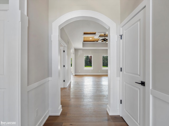 55127 Saint Paul Dr, Macomb Twp, MI 48042 - hallway featuring arched walkways, hardwood / wood-style flooring, baseboards, and a raised ceiling