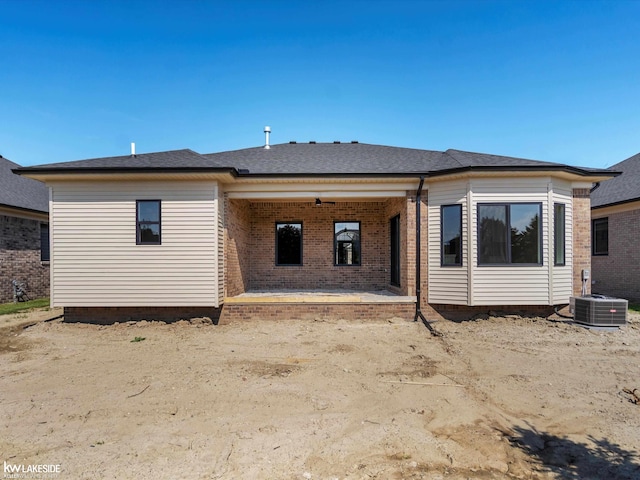 55127 Saint Paul Dr, Macomb Twp, MI 48042 - back of property featuring brick siding, central AC, a patio area, and a shingled roof