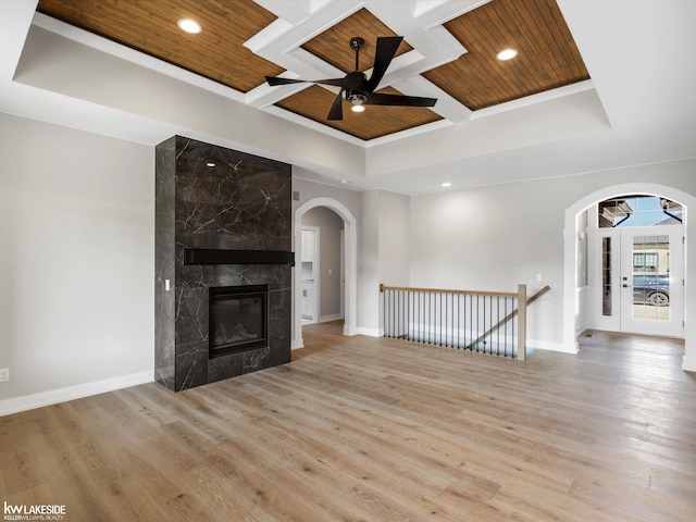 55127 Saint Paul Dr, Macomb Twp, MI 48042 - unfurnished living room featuring wood ceiling with exposed beams, arched walkways, a ceiling fan, coffered ceiling, and baseboards