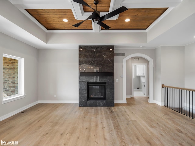 55127 Saint Paul Dr, Macomb Twp, MI 48042 - unfurnished living room with a raised ceiling, wooden ceiling, a ceiling fan, arched walkways, and wood finished floors