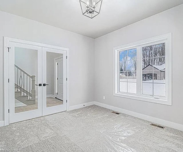 29126 Brooke Meadows Ct, Chesterfield, MI 48047 - carpeted empty room with french doors, baseboards, and a chandelier