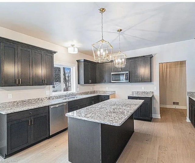29126 Brooke Meadows Ct, Chesterfield, MI 48047 - kitchen with stainless steel appliances, light wood-style flooring, light stone countertops, and a sink
