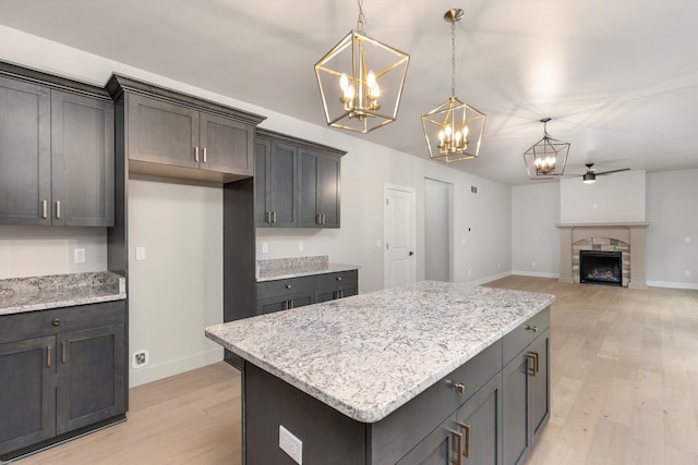 29126 Brooke Meadows Ct, Chesterfield, MI 48047 - kitchen with a chandelier, baseboards, light wood-style floors, and hanging light fixtures
