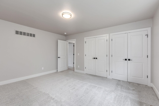 29126 Brooke Meadows Ct, Chesterfield, MI 48047 - unfurnished bedroom featuring two closets, light colored carpet, and baseboards