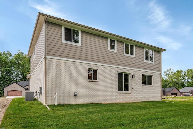 29126 Brooke Meadows Ct, Chesterfield, MI 48047 - back of house with a yard, brick siding, central AC unit, and a detached garage