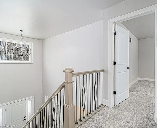 29126 Brooke Meadows Ct, Chesterfield, MI 48047 - hall with an upstairs landing, a chandelier, carpet flooring, and baseboards