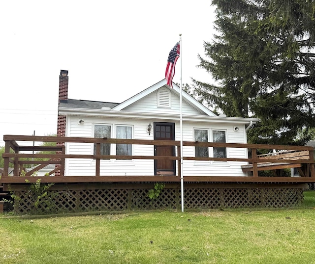 265 Lagoon Beach Dr, Bay City, MI 48706 - rear view of house featuring a wooden deck, a chimney, and a yard