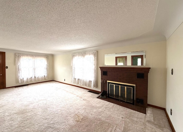 265 Lagoon Beach Dr, Bay City, MI 48706 - unfurnished living room featuring carpet flooring, a textured ceiling, a fireplace, and baseboards