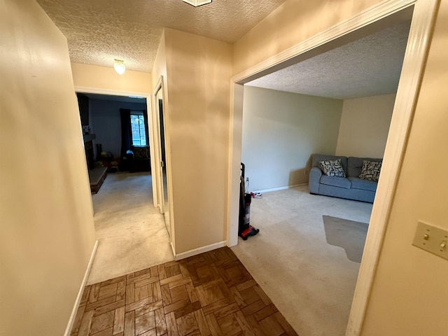 2222 Compton St, Saginaw, MI 48602 - corridor featuring a textured ceiling, carpet floors, and baseboards