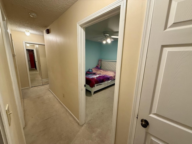 2222 Compton St, Saginaw, MI 48602 - hallway with light colored carpet, a textured ceiling, and baseboards