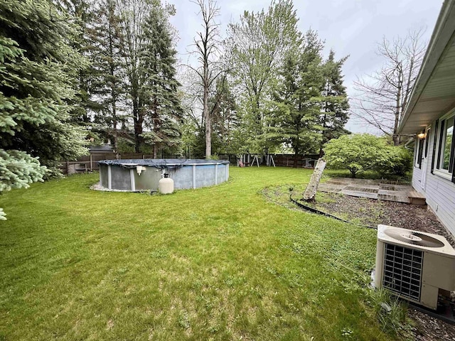 2222 Compton St, Saginaw, MI 48602 - view of yard featuring cooling unit and a covered pool