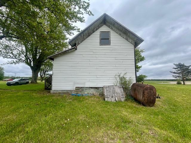 4992 Freeman Rd, Beaverton, MI 48612 - view of home's exterior with a yard